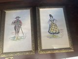 two framed pictures of a man and a woman on a shelf