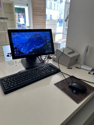 a computer on a desk with a keyboard and mouse