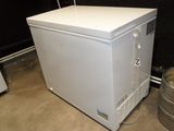 an image of a small white refrigerator in a room