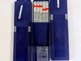 three blue batteries are sitting in a row on a white surface