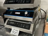 three commercial electric fryers sitting on top of a counter in a kitchen