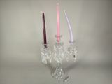 two candles that are sitting in a glass holder