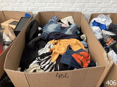 a cardboard box filled with clothes and other items