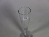 a glass with a sticker on it sitting on a table
