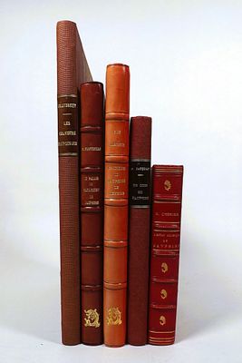 a lot of books that are stacked on top of each other