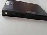 a black laptop with a yellow button on it