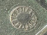 a close up of a metal object with a clock on it