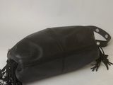 a black leather purse with fringes on a white background