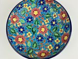 an image of a colorful plate with flowers painted on it