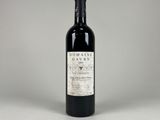 a bottle of wine sitting on top of a white table