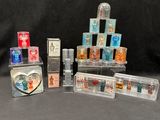 many different types of perfumes on display on a black background