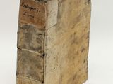 an old book sitting on top of a white surface