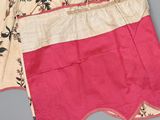 pair of pink and white floraled shorts with pink trims