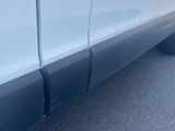 a close up of a white truck parked in a parking lot