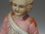 a small figurine of a boy with a cane
