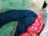 a pile of clothes in a basket on the floor