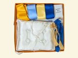 a box with a tie, a handkerchief, and other items in it