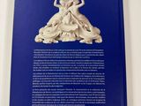 a blue book with a picture of a woman holding a vase