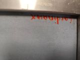 a close up of a microwave with a red writing on it