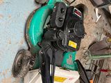 a picture of a pile of tools and a lawn mower