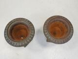 two brown candles that are sitting on a white table