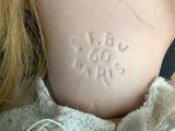 a close up of a doll ' s chest with writing on it