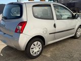 a picture of a small silver car parked in a parking lot