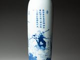 a blue and white vase with a picture of a man riding a horse