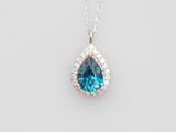 a blue topaz and diamond pendant on a silver chain