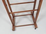 a wooden table with a glass top on wheels