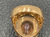 an image of a gold ring with a stone in the center