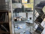 a glass display case with magazines on it in a room