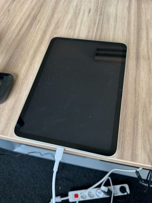 une tablette posée sur un bureau en bois