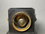 a small clock that is sitting on top of a table