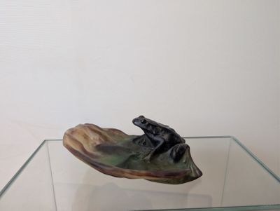 a glass table with a small sculpture on top of it