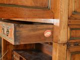 a wooden cabinet with two drawers and a drawer with a drawer underneath it