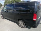 a picture of a black van parked in a parking lot