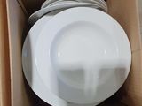 a cardboard box with a bunch of plates inside of it