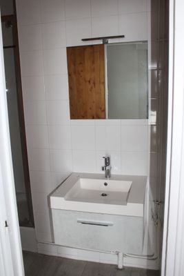 a bathroom with a sink and a mirror in it