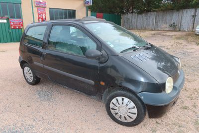 une petite voiture noire garée devant un bâtiment