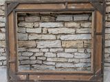 a picture of a picture of a stone wall with a wooden frame