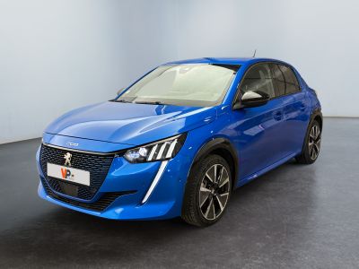 the blue car is parked in a room with a black floor