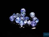 a bunch of blue sapphires on a black surface