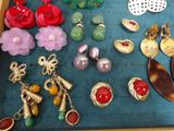 many different types of jewelry displayed on the table