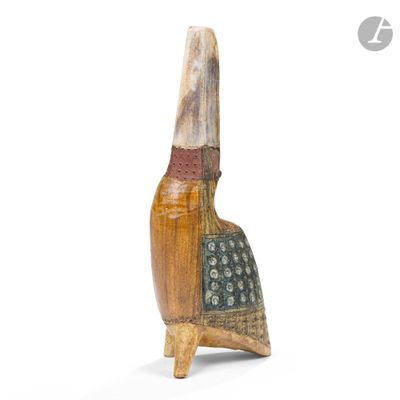 a close up of a wooden sculpture of a bird on a stand