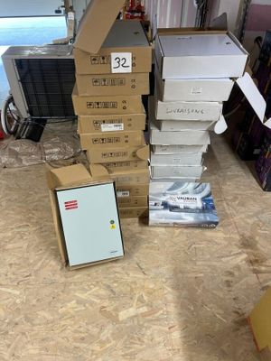 a pile of boxes sitting on the floor next to a picture frame