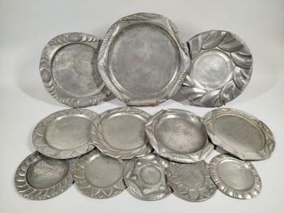 several silver plates and trays sitting on a white surface