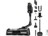 a black and white photo of a vacuum cleaner and accessories