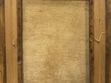 an old picture frame with a piece of wood in the middle of it