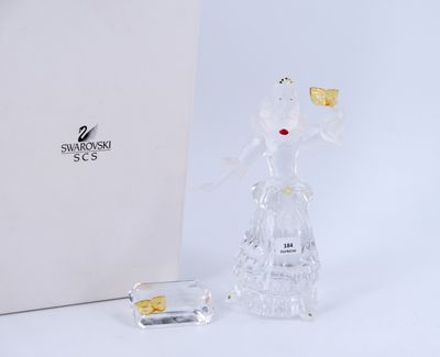 a glass figurine of a woman holding a goldfish